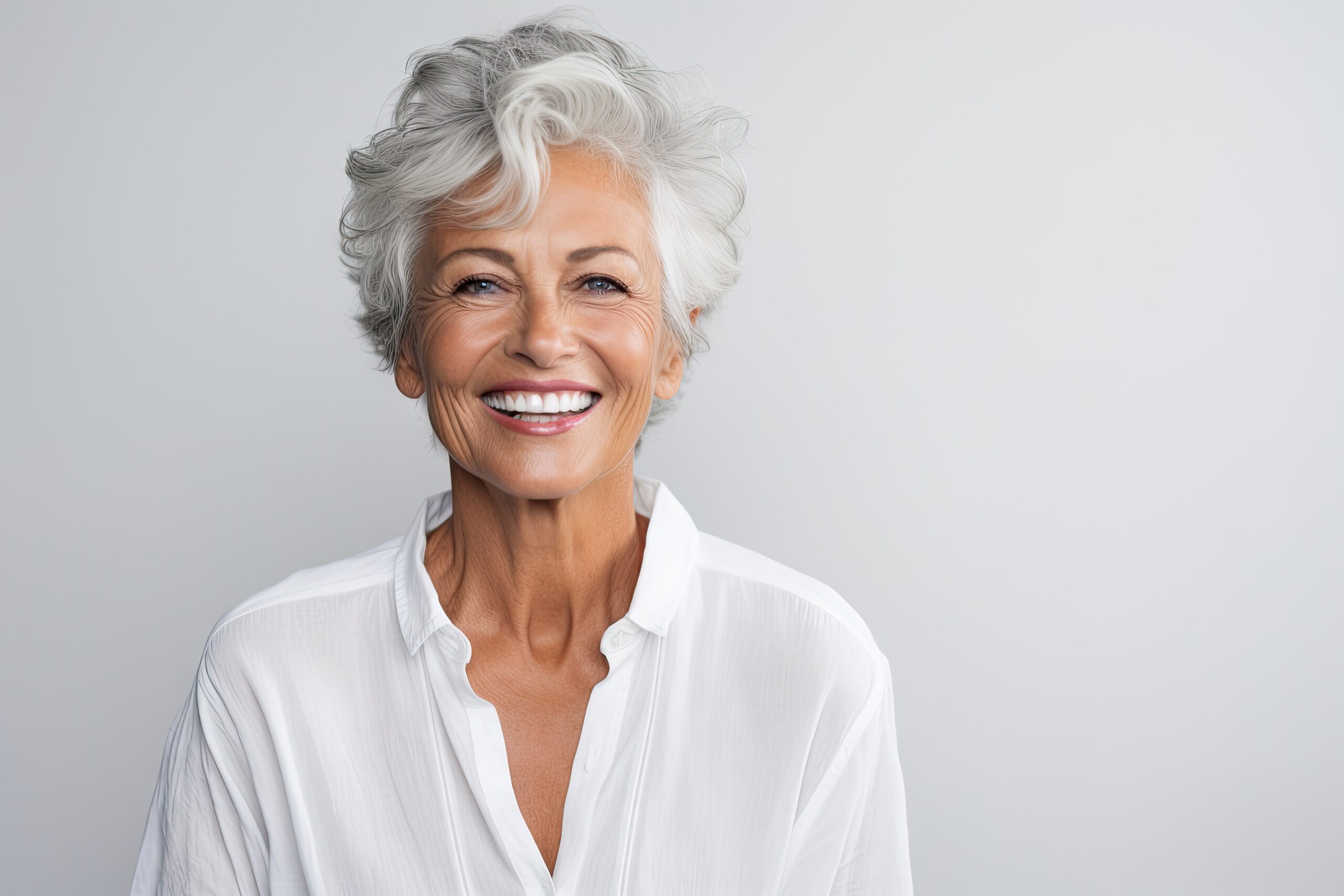 Beautiful gorgeous 50s mid age beautiful elderly senior model woman with grey hair laughing and smiling. Mature old lady close up portrait. Healthy face skin care beauty, skincare cosmetics, dental.